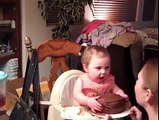 This baby tastes cake for the first time.