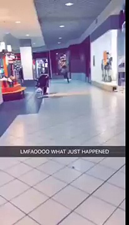 Woman stops a man running from mall security.
