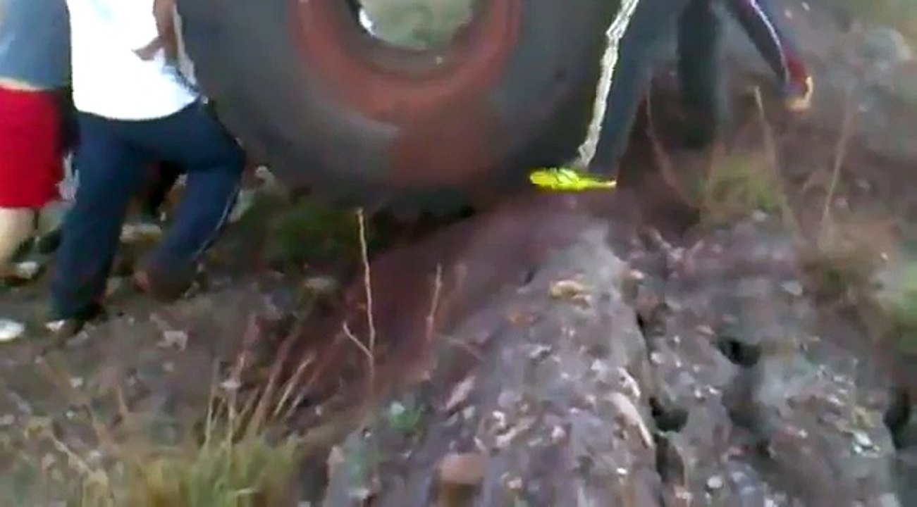 Huge Tire Bouncing Downhill Into Lake