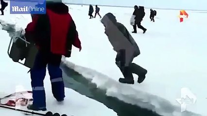 Hundreds of fishermen frantically when chunks of ice lakes in Magadan Russia cracking two separate