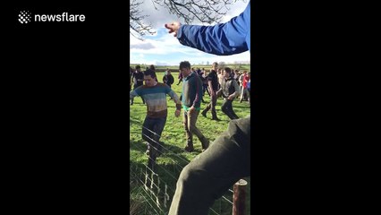 Bottle kicking match takes place on mile-long pitch in English village