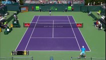 Viktor Troicki jumps the net to retrieve a ball