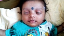 Cute Baby Sleeping with Eyes Open