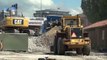 CAT 323D loading crusher with demolition debris