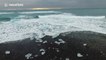 Beautiful footage of waves crashing into small icebergs in a glacier lagoon