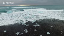 Beautiful footage of waves crashing into small icebergs in a glacier lagoon