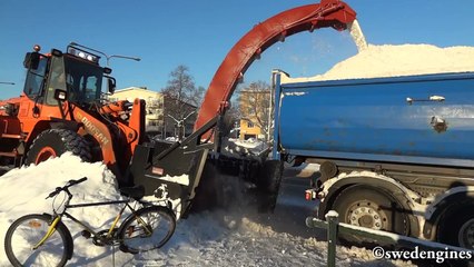 Doosan DL250 with snowblower loading trucks