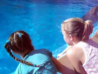 GIRLS PETTING DOLPHINS