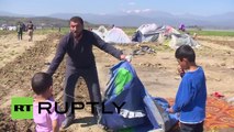 Greece: Farmer PLOUGHS land where refugees are living in tents