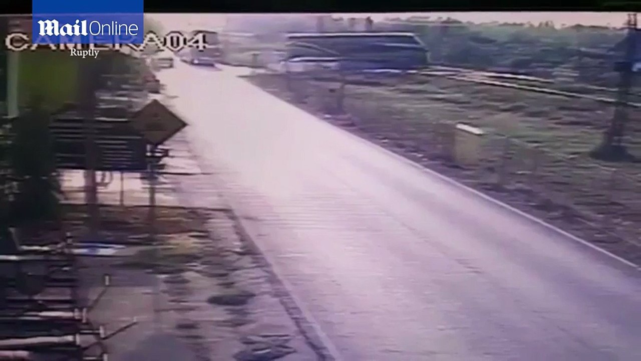 Deadly crash involving a tour bus and a train caught on CCTV