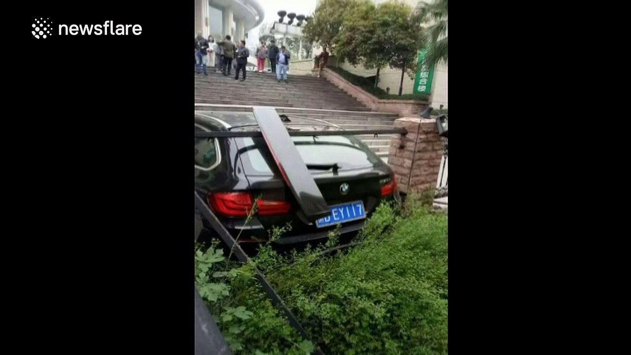 BMW crashes down stairs after driver presses accelerator by mistake