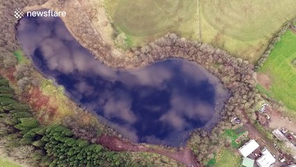 Amazing, high drone flight over cloud-covered lake