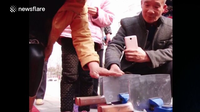 Kung-fu chef stands on meat cleavers and cuts meat on a balloon without popping it