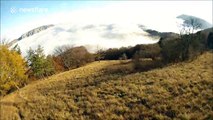 Epic paragliding flight above the clouds
