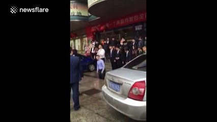 Chinese employees crawl along pavement after failing to achieve sales targets