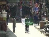 Masked youngsters raise Pakistan flags in Srinagar