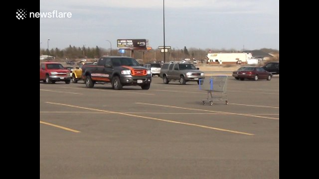 Rogue shopping trolley narrowly misses parked cars