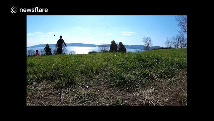 Drone captures stunning images of kids running down a hill in park