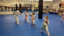 Children learning self defense with the elbow strike at Henrich US Taekwondo.