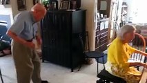 An old man is dancing behind his wife