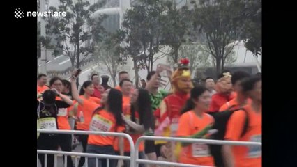 Chinese marathon runners take selfies with cosplaying participants