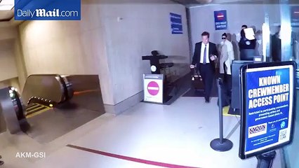 Kourtney Kardashian flashes a smile after her arrival into LAX