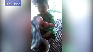 Youngster gets excited eating boiled SNAKE for the first time