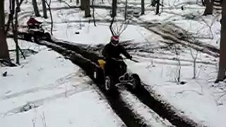 atvs messing around on small track in woods
