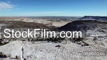 Aerial drone fly high mesa top flat plains winter snow covered hogback.  COLORADO