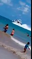Barco em alta velocidade passa a poucos metros de banhistas na praia de Camboinha litora da Paraíba