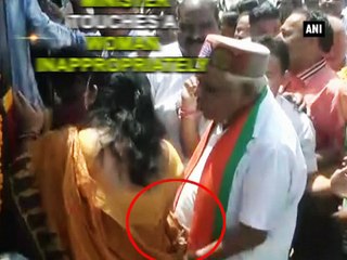 MP Home Minister touches a woman inappropriately