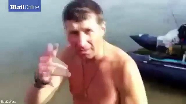 Shocking moment Russian man gets fish attached to his manhood
