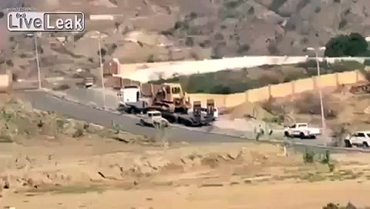 Truck carrying Bulldozer nearly crushes Worker
