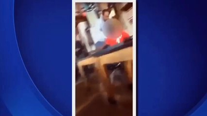 a teacher's aide pushing a student onto a desk hen holding him by his neck (MILWAUKEE)