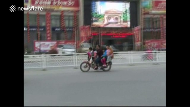 Six people travel on overloaded motorbike