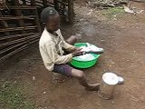 Think Humanity, boy in Kyangwali washing his new Crocs.