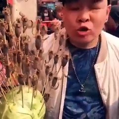 A man eating scorpions sold on the market