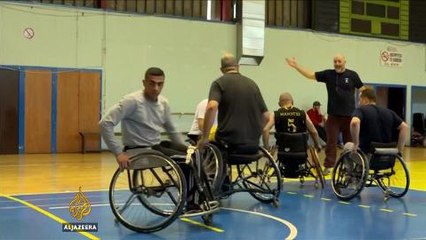 Syrian athlete carries Olympic flame through Athens refugee camp