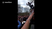 Partying student jumps out of a window onto a table