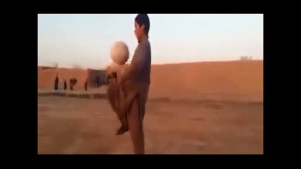 Young Hazara boy performing soccer tricks wity football