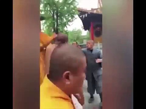 Monks fight inside buddist temple as tourists try to pull them apart