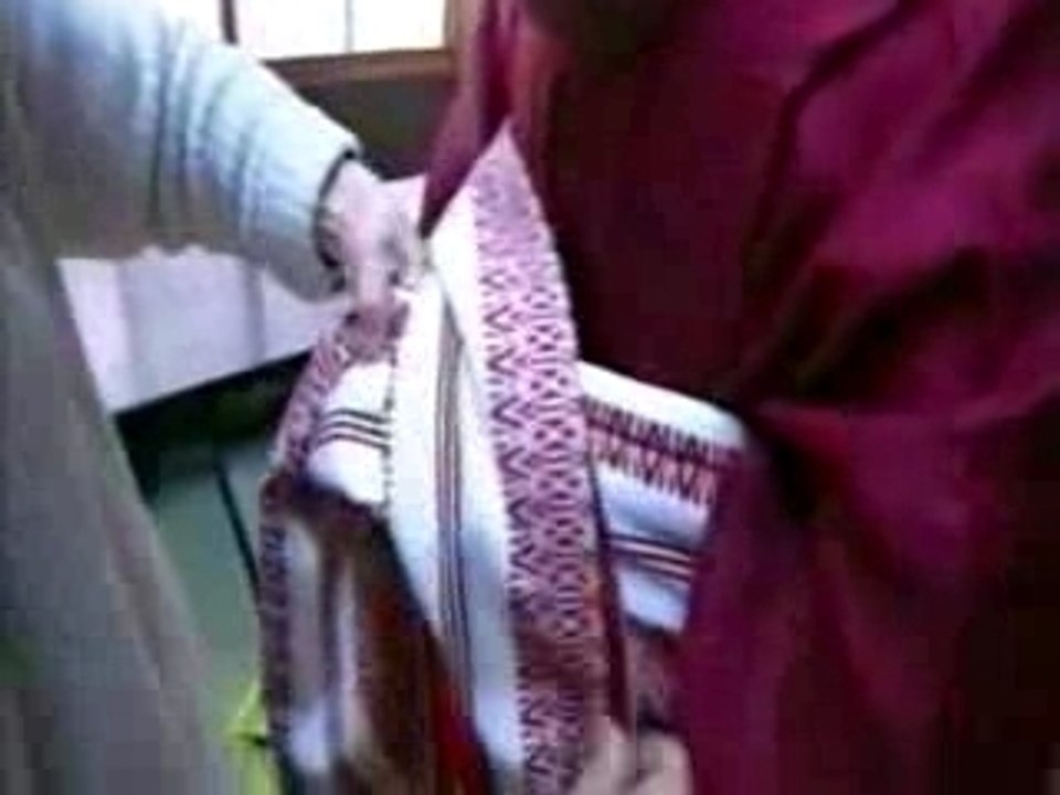 Geisha being dressed in kimono