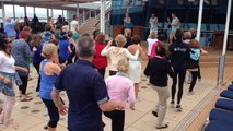 Aerobic dance exercise by the pool side of the Celebrity Equinox