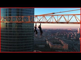 Daredevils Fearlessly Hanging From a Crane in Moscow