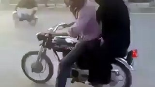 Boy wheeling on Bike with his GF