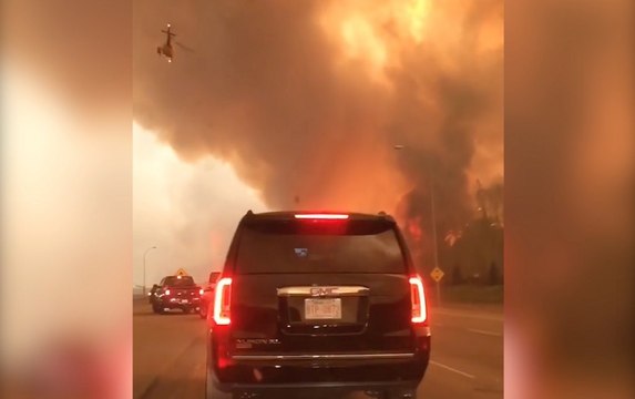 Watch residents flee from wildfire burning in Canadian town