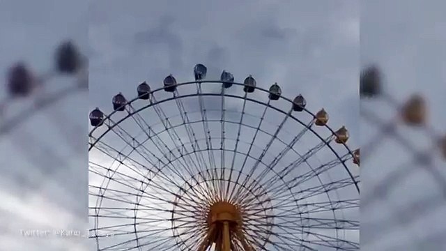 Dramatic footage of ferris wheel carts spinning in winds