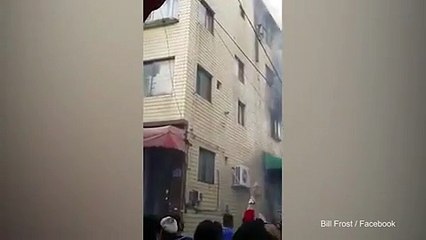 Shocking moment woman drops 3 kids from burning building