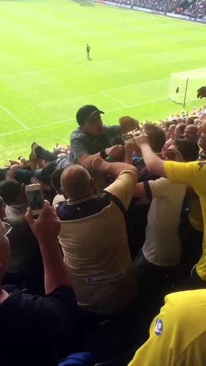 Leeds United fan crowd surfs on a surf board v Preston North End Football Club