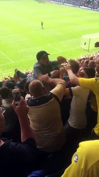 Leeds United fan crowd surfs on a surf board v Preston North End Football Club